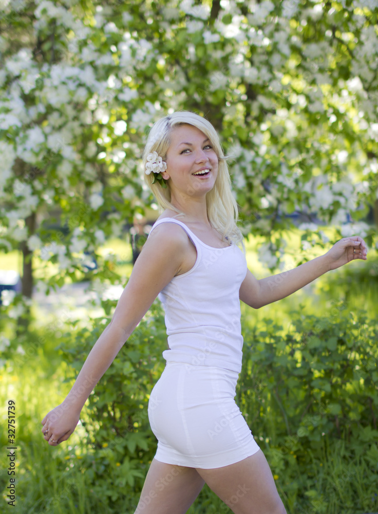 Beautiful joyful blonde walks in summer park Beautiful joyful blonde walks in summer park
