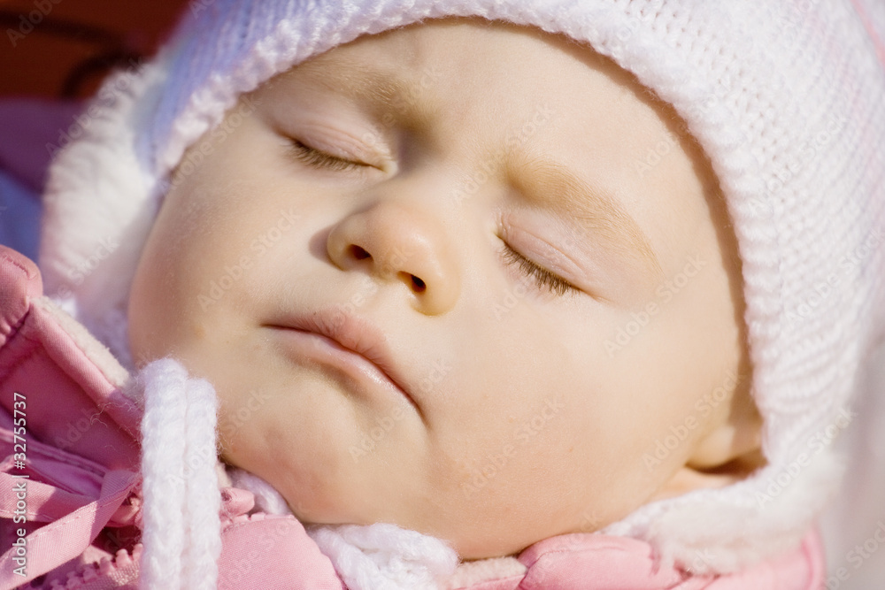 little girl in a pink jacket sleeps in a carriage little girl in a pink jacket sleeps in a carriage