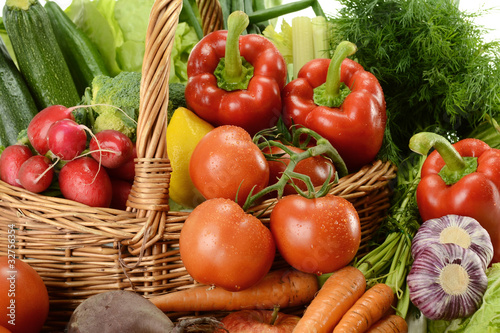 Composition with raw vegetables and wicker basket