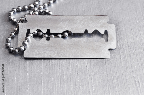 Brushed silver metal with razor blade.