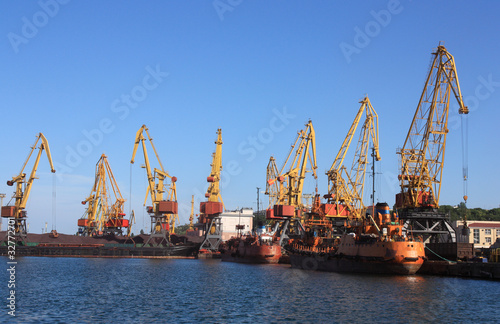 cranes in a port, unloading ships