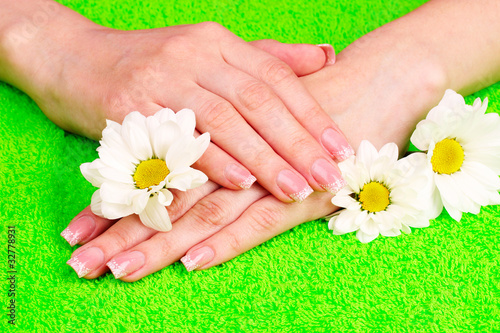 Beautiful hand with perfect nail french manicure  on towel backg