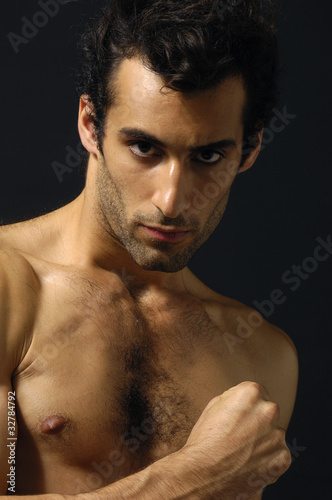 young sensual man on a black background