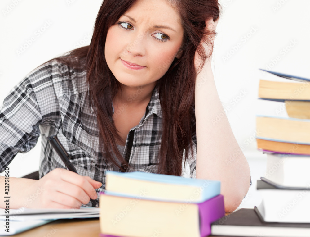 Attractive red-haired girl studying for an examination Attractive red-haired girl studying for an examination
