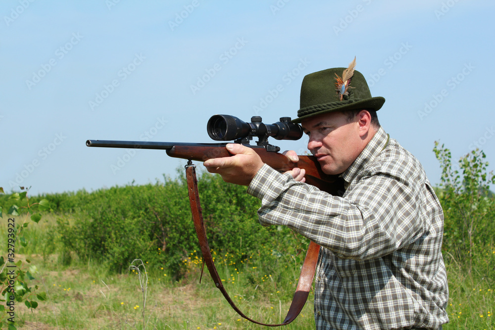 Fototapeta premium hunter aiming with sniper rifle