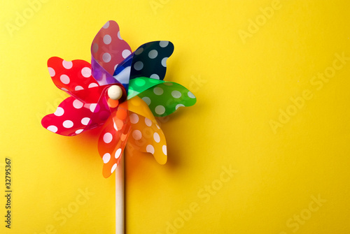 Windmill toy isolated on yellow background