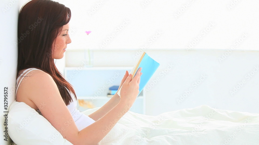 Beautiful brunette reading a book