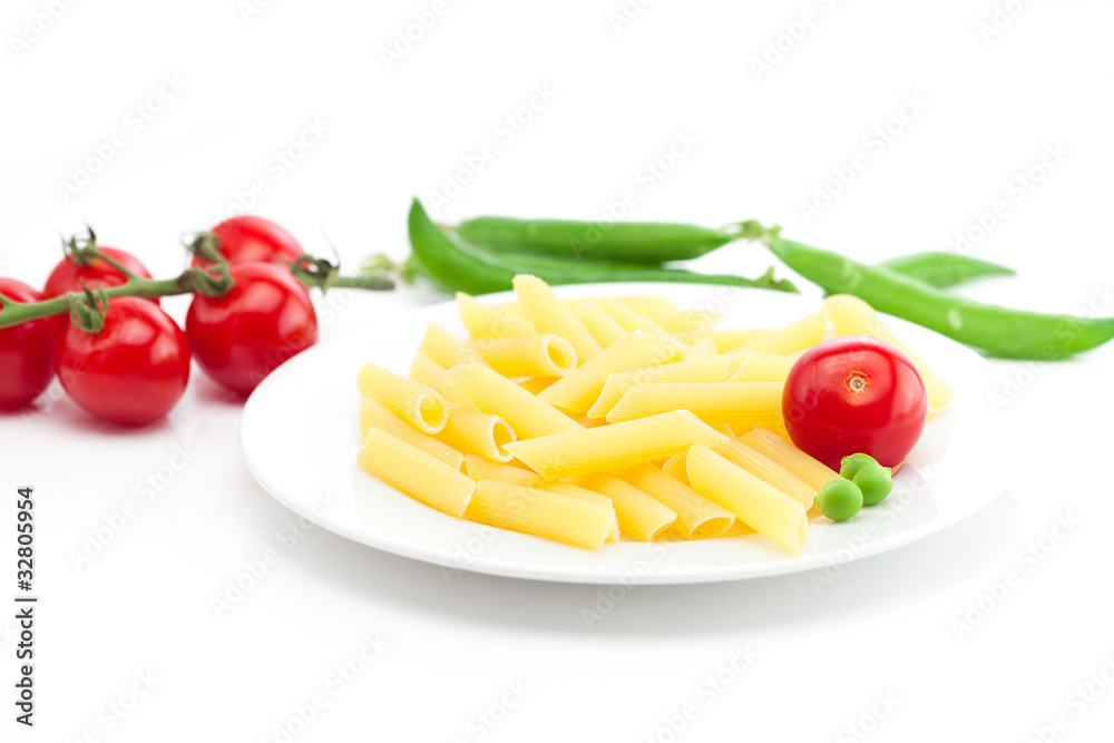 tomato, peas and pasta on a plate isolated on white