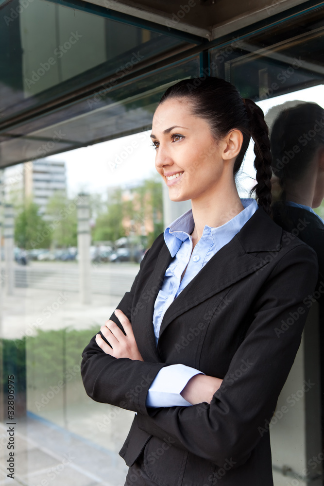 businesswoman standing by her building office businesswoman standing by her building office