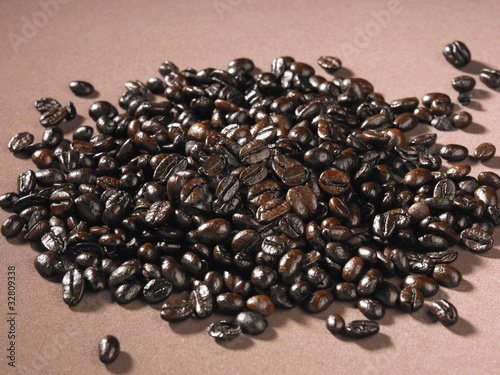 Roasted coffee beans on brown background. photo