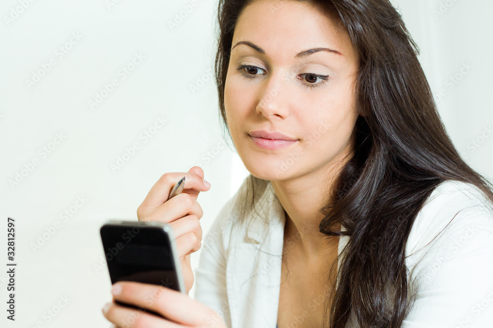 Businesswoman consulting their mobile phone Businesswoman consulting their mobile phone