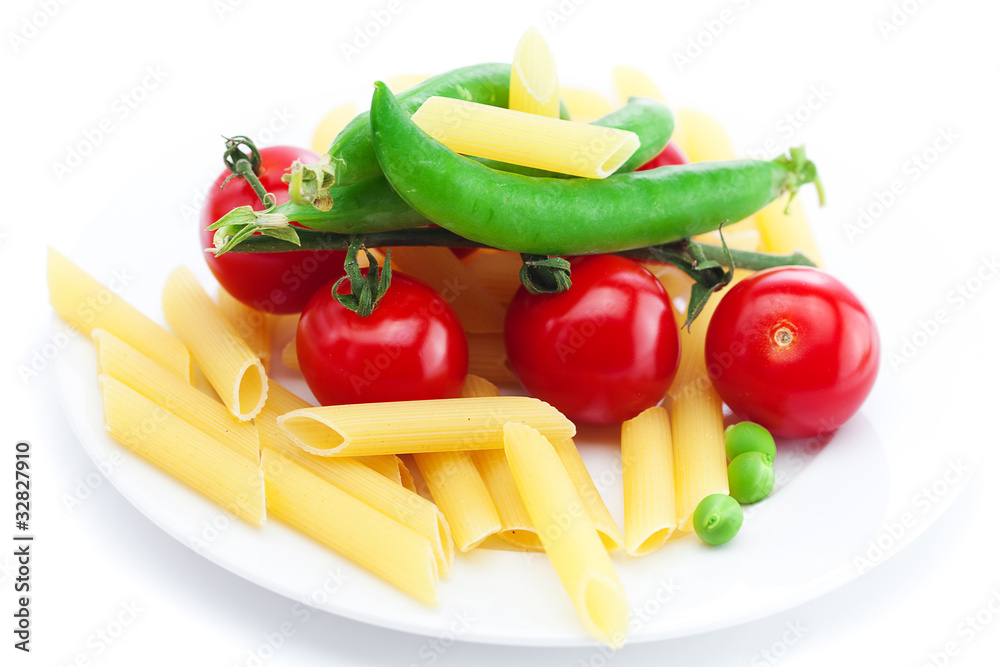 tomatoes, peas, pasta on a plate isolated on white tomatoes, peas, pasta on a plate isolated on white