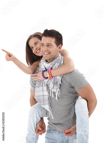 Happy guy carrying girlfriend on back