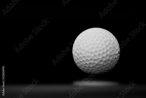 Golf ball in black background