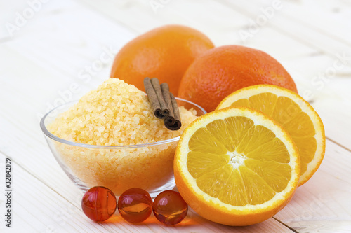 bowl of orange bath salt with fresh fruits - beauty treatment