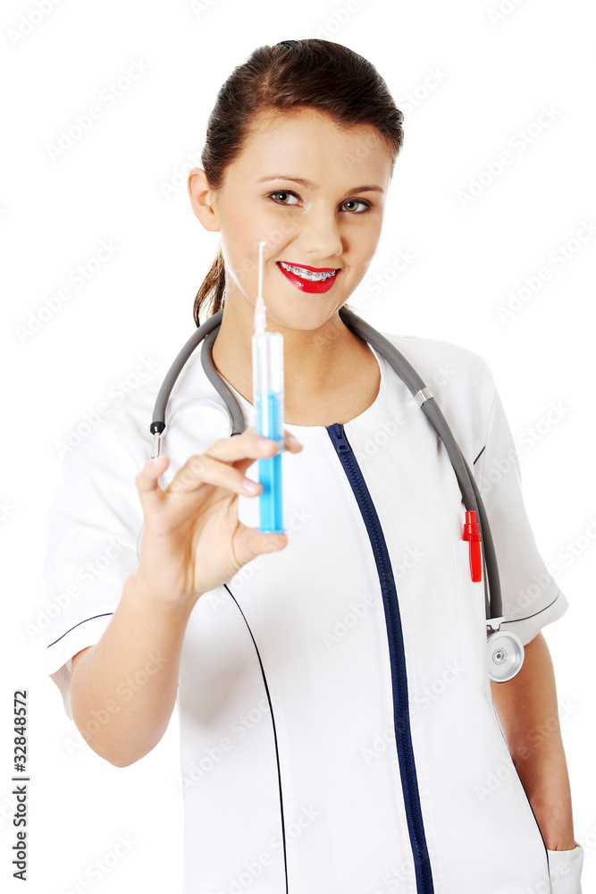 Young female doctor or nurse holding syringe Young female doctor or nurse holding syringe