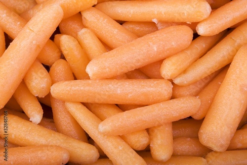 Raw mini baby carrots closeup photo