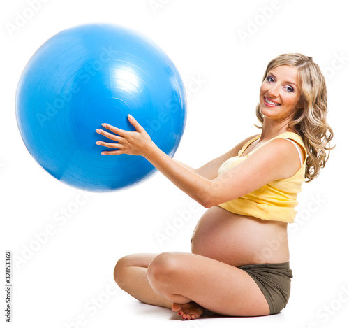 Pregnant woman with gymnastic ball isolated on white