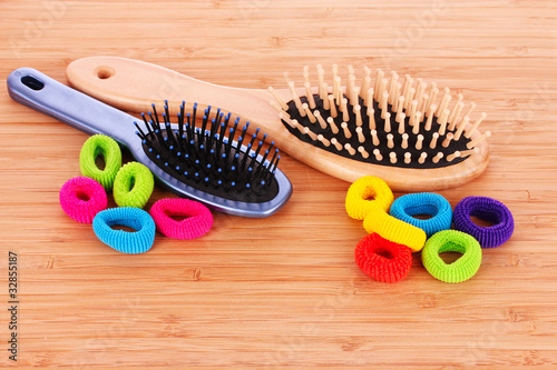 Hair Brush and hair scrunchies on brown background