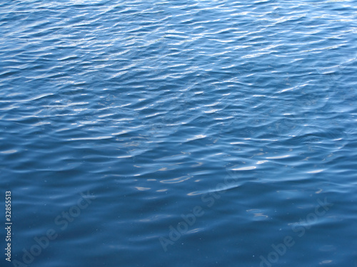 Small waves on pure blue sea water