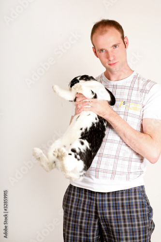 young man saves an experimental animal which has fear photo