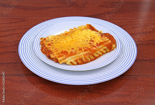 Lasagna on two blue plates