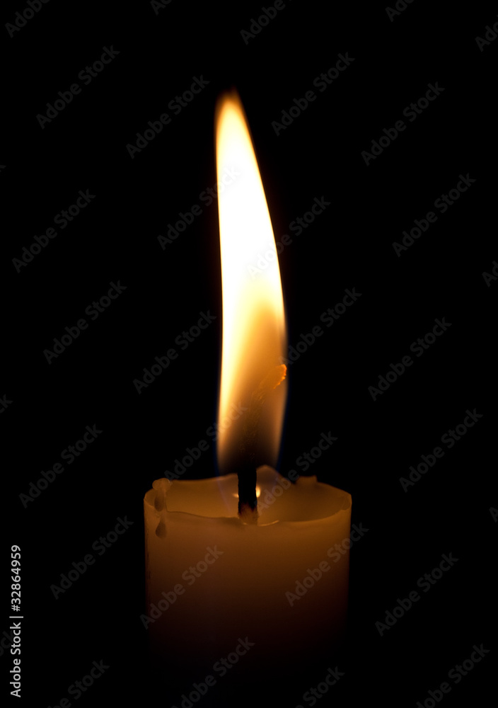 Burning candle on a black background Burning candle on a black background
