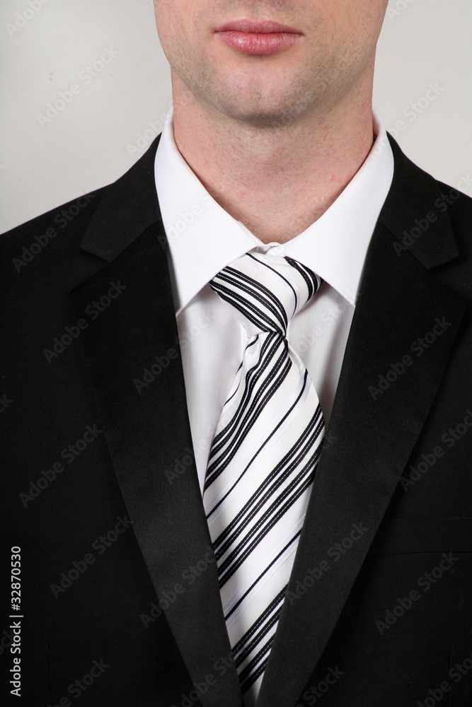 Portrait of businessman wearing a black suit and black white tie