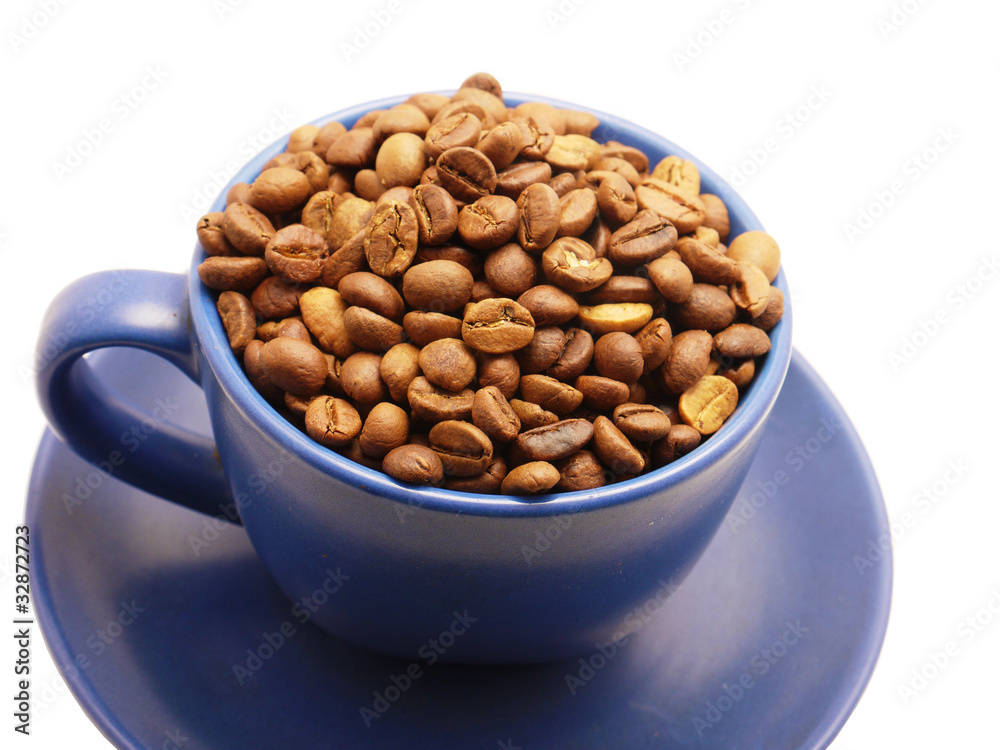 Coffee grains in a blue cup on a white background