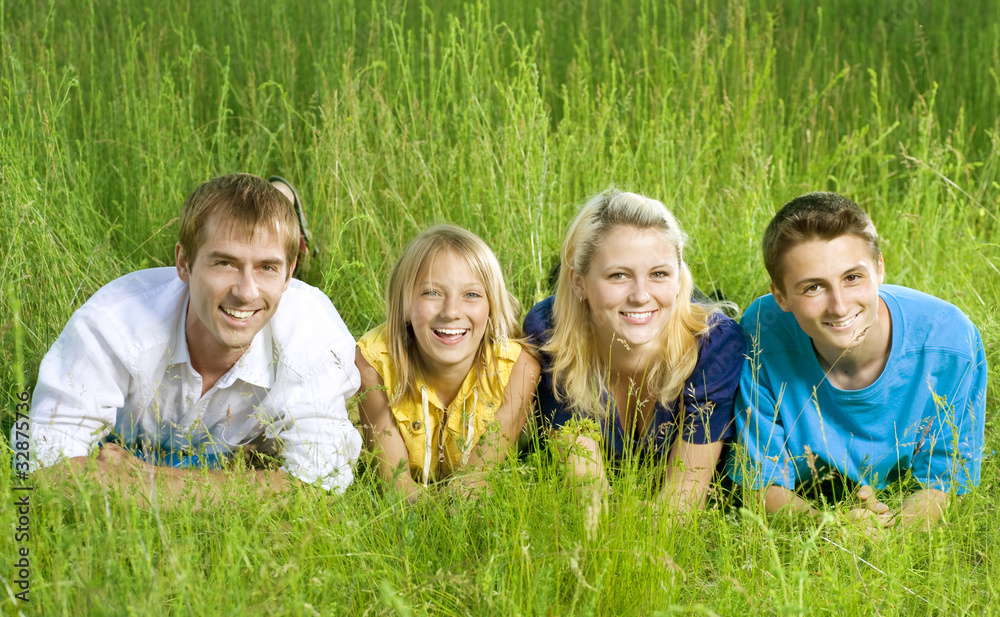 Happy Friends outdoor lying on a green grass Happy Friends outdoor lying on a green grass