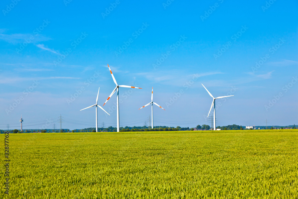 Wind energy wowers standing in the field in spring Wind energy wowers standing in the field in spring