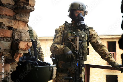 Army Soldier with weapons and gas mask.