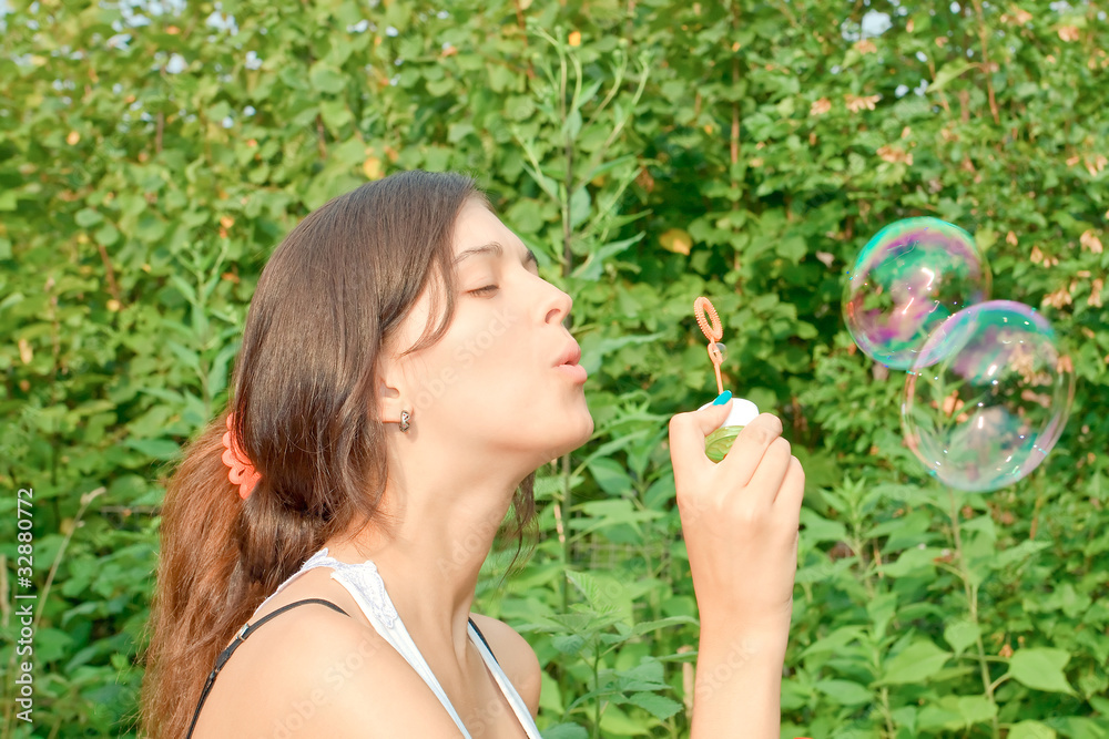 attractive girl blowing soap bubbles attractive girl blowing soap bubbles