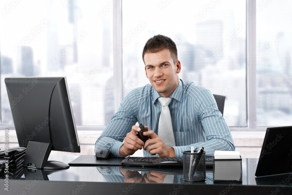 Young manager smiling at desk Young manager smiling at desk