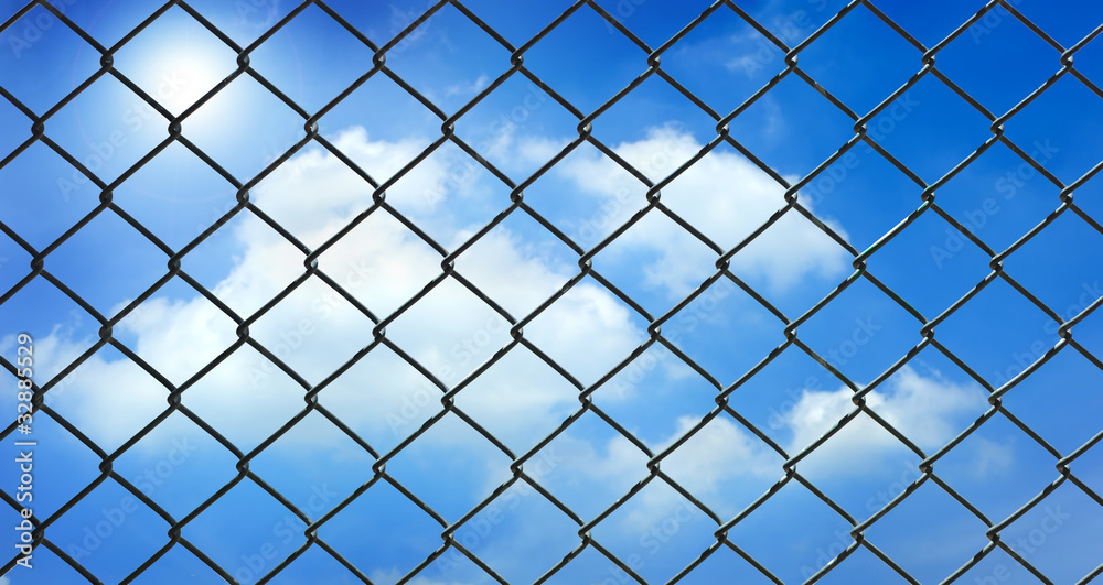 iron wire fence on blue sky background iron wire fence on blue sky background