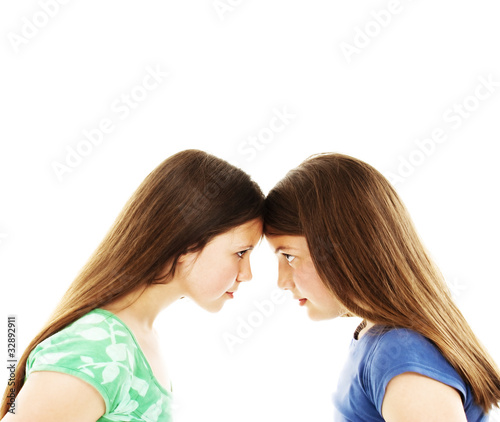 Two teenage sisters staring at each other