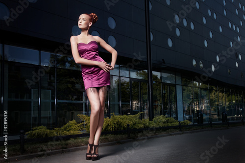 Fine art photo of a beautiful woman in front of a building