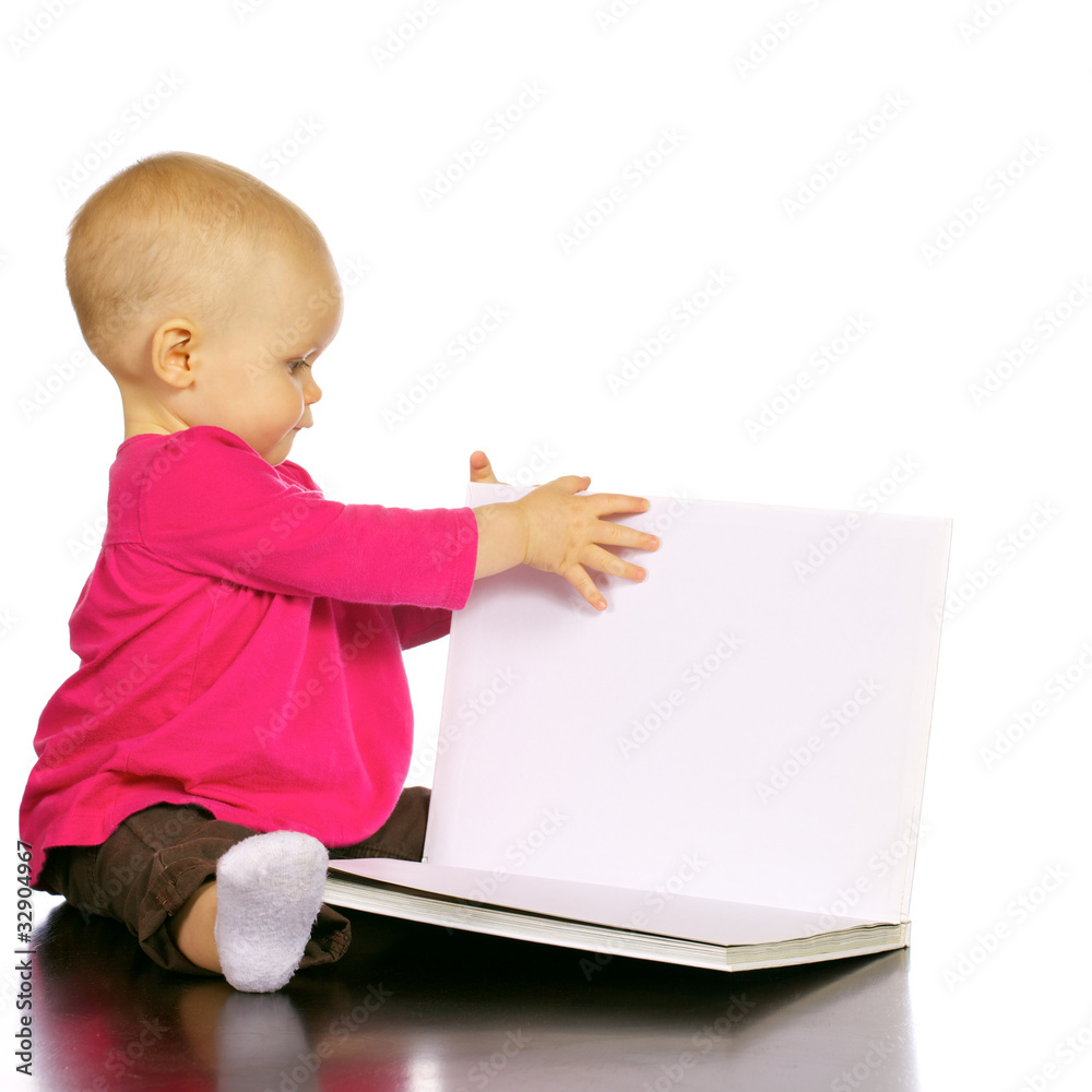 Infant baby girl enjoying and discovering books Infant baby girl enjoying and discovering books