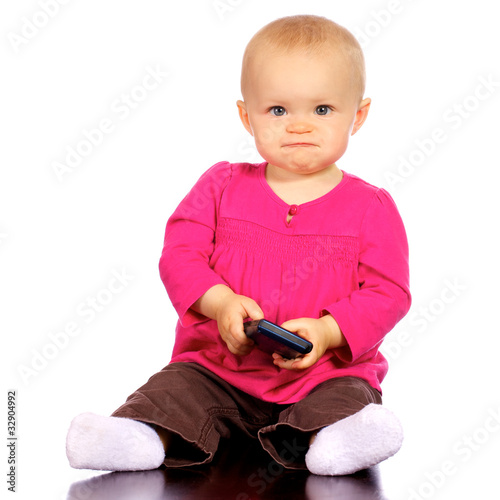 Infant girl trying to figure out how cell phone works