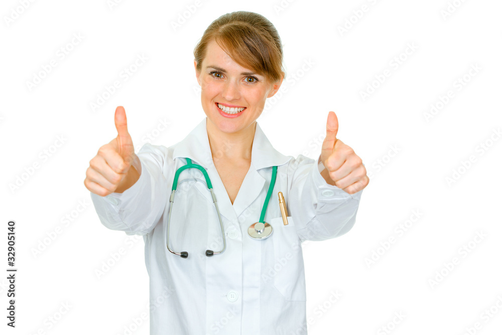 Smiling medical doctor woman showing thumbs up gesture Smiling medical doctor woman showing thumbs up gesture