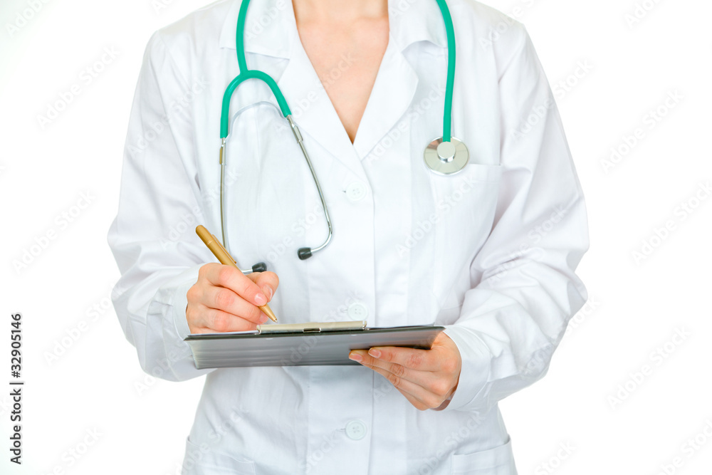 Medical female doctor making notes in document. Close-up.