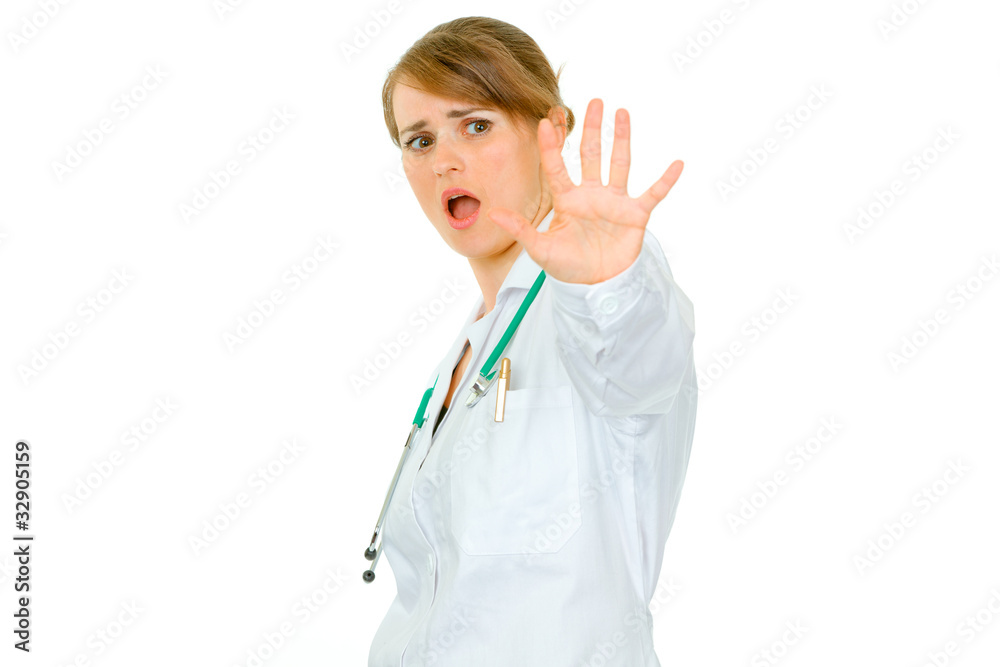 Scared young medical female doctor isolated on white. Scared young medical female doctor isolated on white.