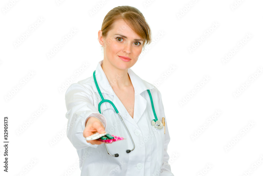 Smiling medical female doctor holding packs of pills in hand Smiling medical female doctor holding packs of pills in hand