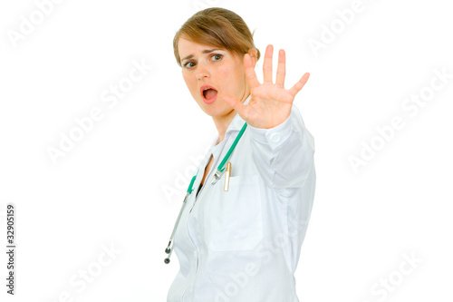 Scared young medical female doctor isolated on white.