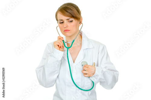Doctor woman listening to her heart with stethoscope
