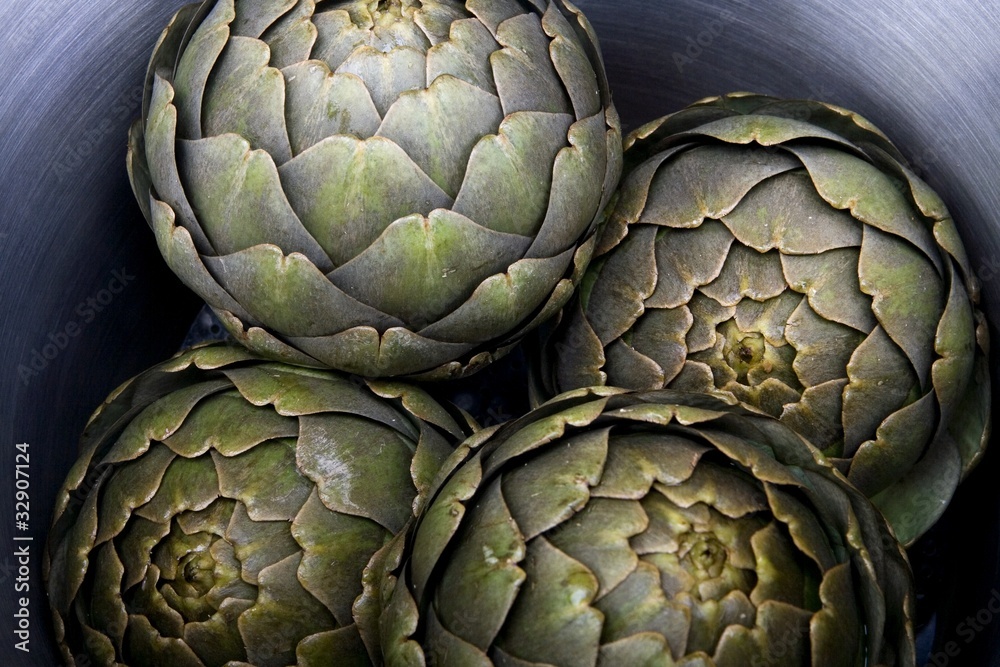 Fototapeta premium Steamed artichokes in a large pot