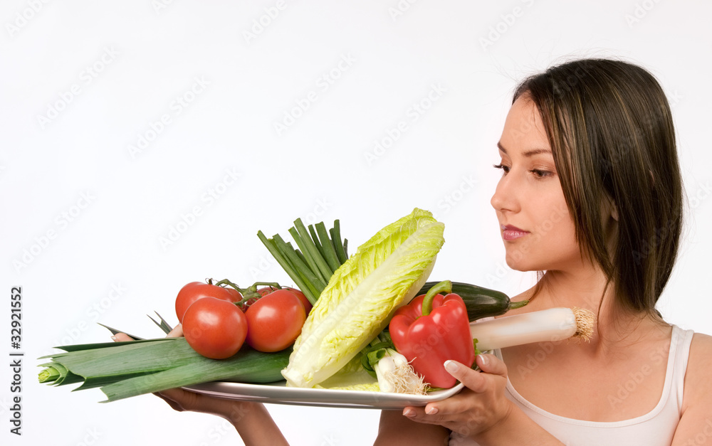 Young woman holding a plate with fresh vegetables Young woman holding a plate with fresh vegetables