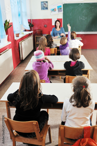 happy kids with teacher in school classroom