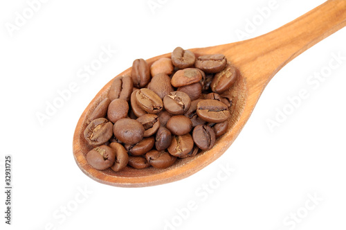 Coffee beans in wooden spoon, isolated on a white background
