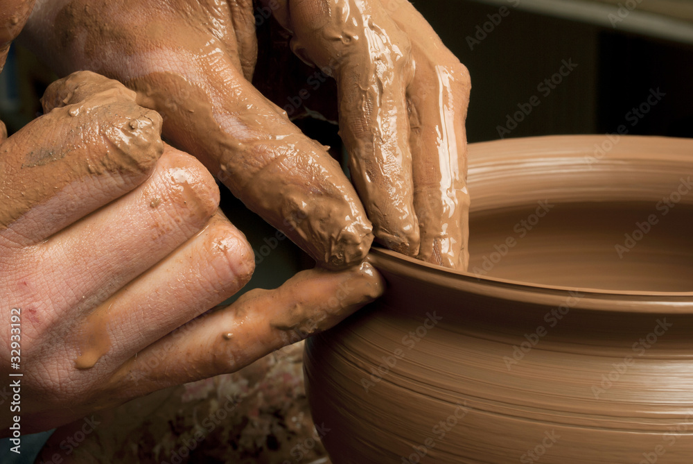hands of a potter, creating an earthen jar on the circle hands of a potter, creating an earthen jar on the circle